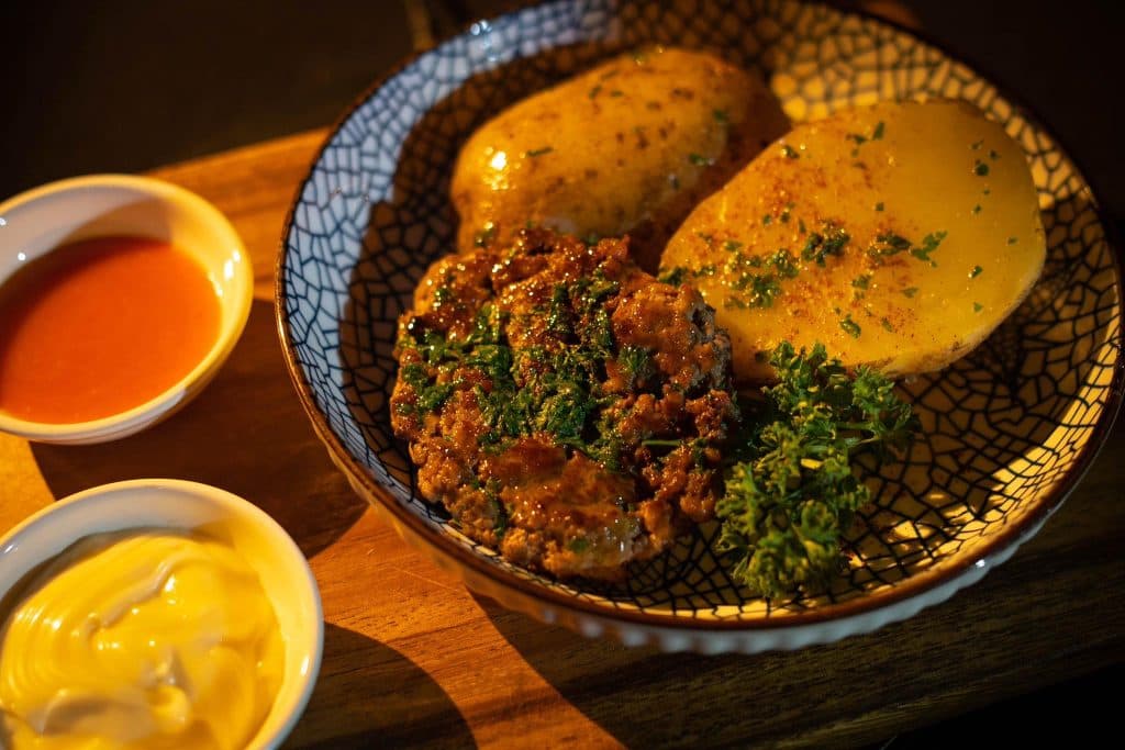 Plated main with roast potatoes and dipping sauces