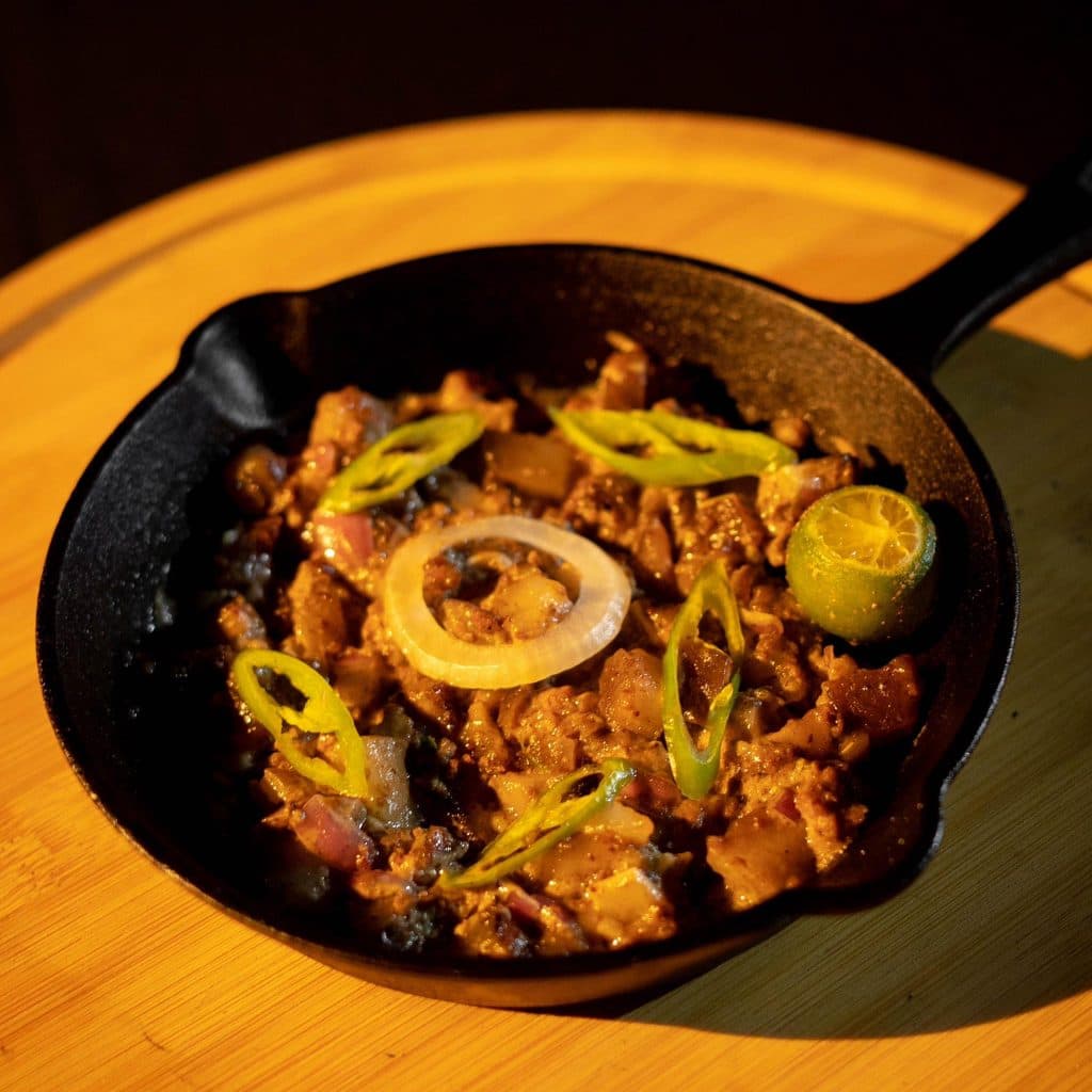 Sizzling dish served in a cast-iron pan