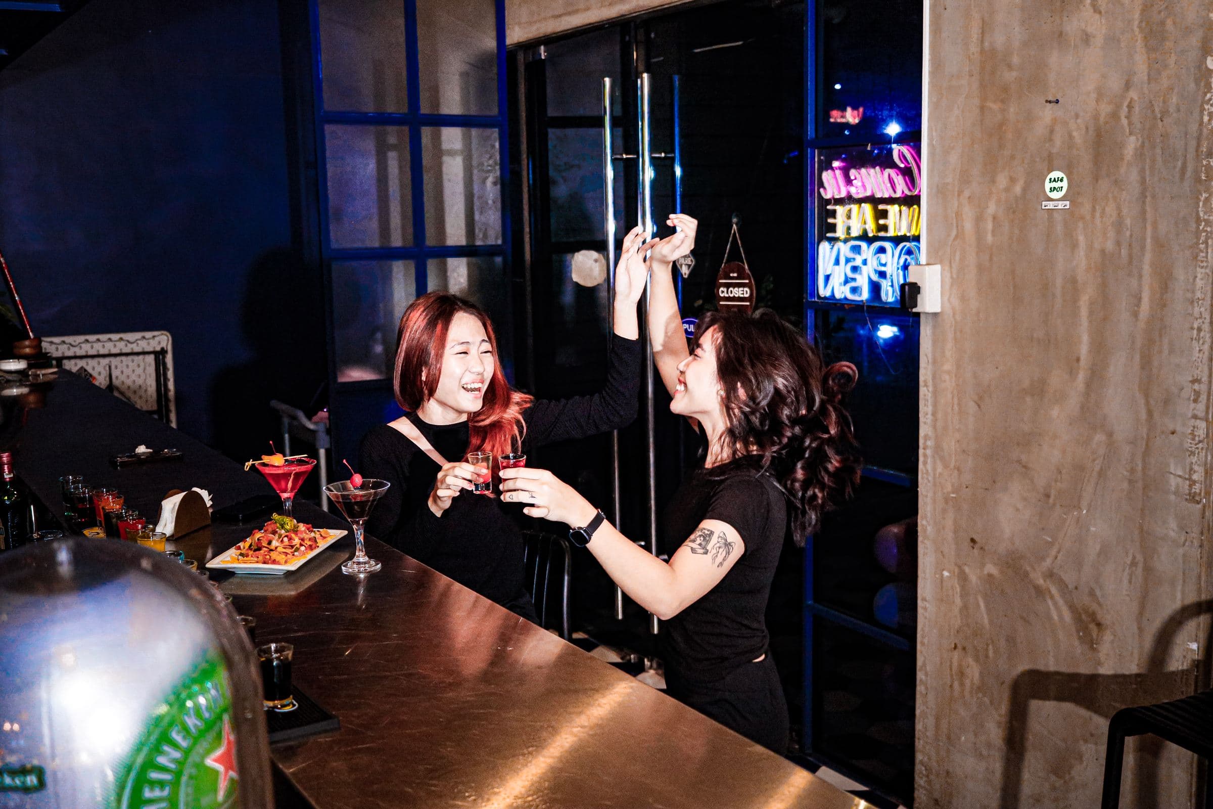 Guests toasting cocktails at the Y2K bar