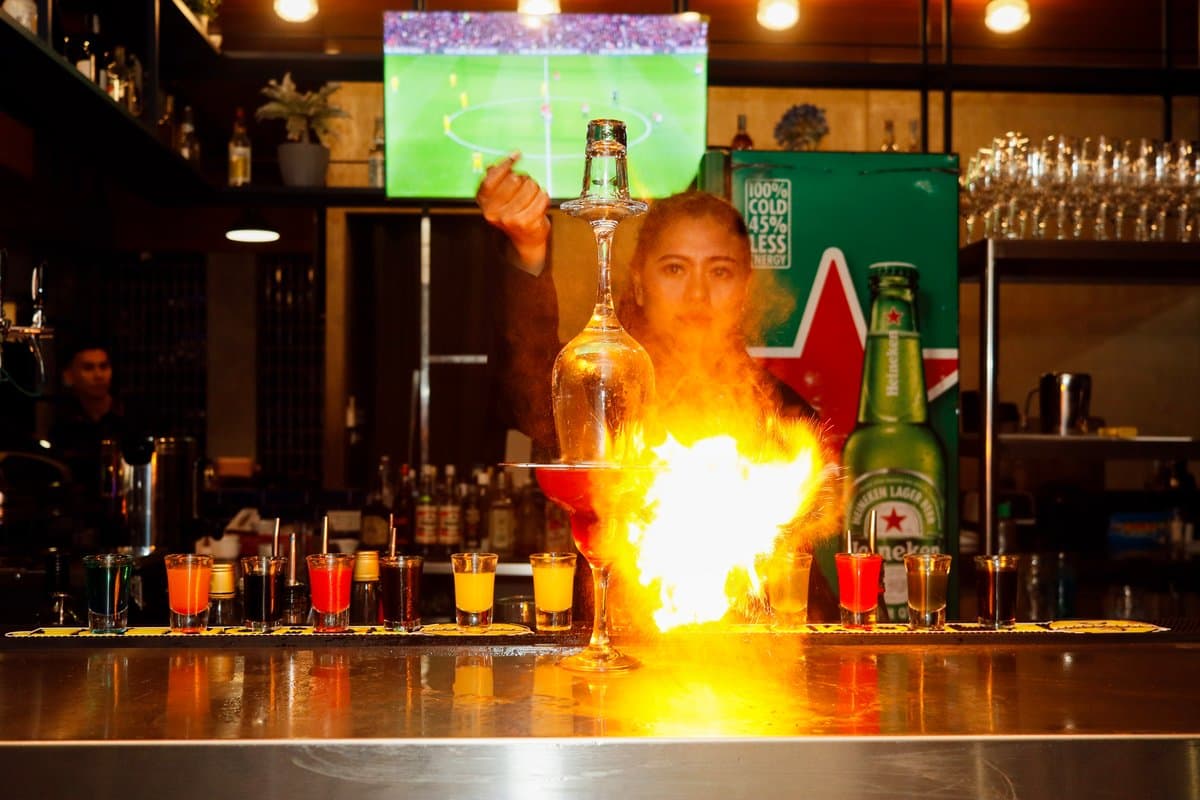 Flaming cocktail lit up at the bar