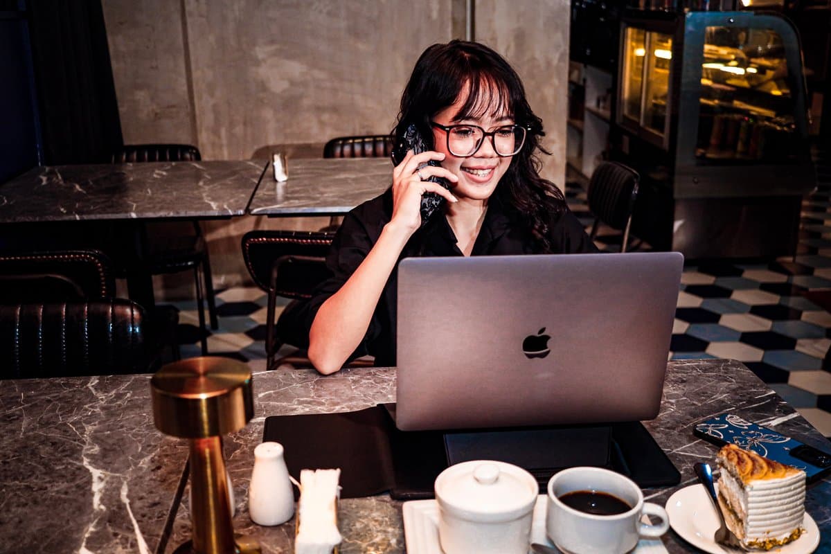 Guest on a call with a laptop and coffee in the dining room