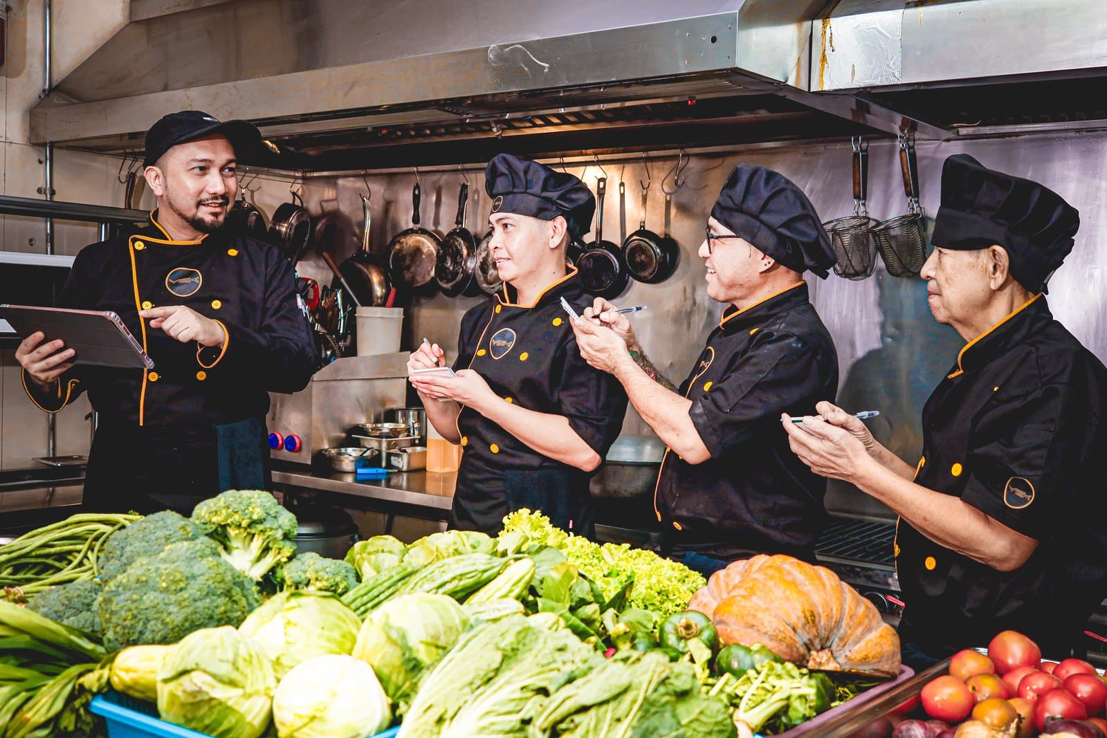 Y2K chefs reviewing the menu over fresh vegetables