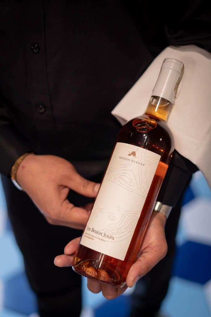 Server presenting a bottle of rosé wine